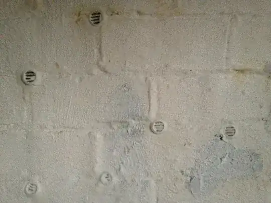 Vents hammered into mortar of a brick foundation