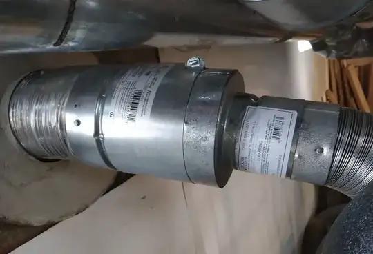 Flue liner passes through mortar sleeve and adapts to Type B gas vent