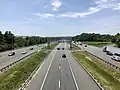 I-95 with a reversible E-ZPass HOT lanes in Dumfries. Authorized vehicle-only median breaks can be seen connecting the main freeway carriageways to the express lanes.