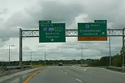 Left:junction:ref=1Bdestination:ref=I 65 Southdestination:street:to=Western Kentucky Parkwaydestination=Nashville;PaducahRight:junction:ref=1Adestination:ref=I 65 Northdestination=Elizabethtown;Louisville