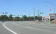 An urban expressway segment of Lawrence Expressway in San Jose, California. Due to the high speed limit (even at this traffic signal), the curve in the road is relatively gentle.