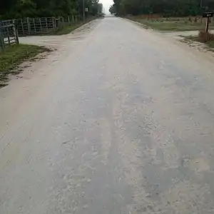 surface=compacted - surface=unpaved may mean this kind of surface