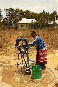 Manual rope pump on a water well head