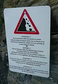 Rockslide warning at the Bisse du Ro, Canton Valais, Switzerland(traffic_sign=hazard + hazard=landslide)