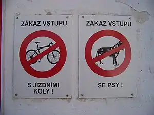 Sign on the left is forbidding entrance with a bicycle - not only riding on a bicycle